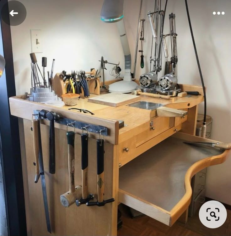 a wooden workbench with many tools on it