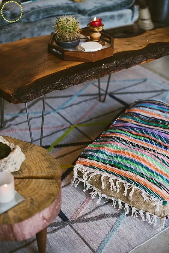 a wooden table sitting on top of a rug next to a couch