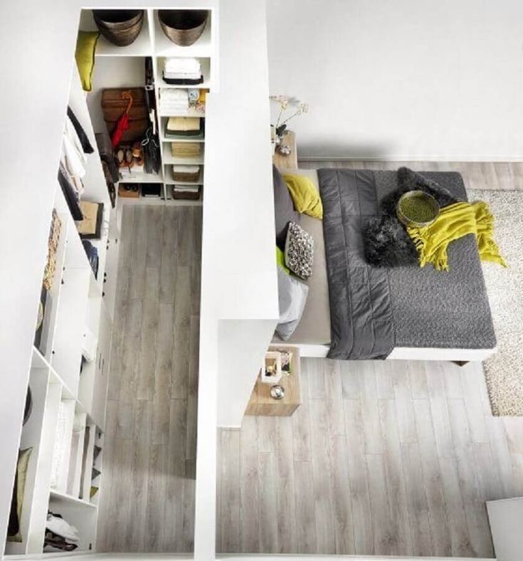 an overhead view of a bedroom with white walls and wood flooring on the floors