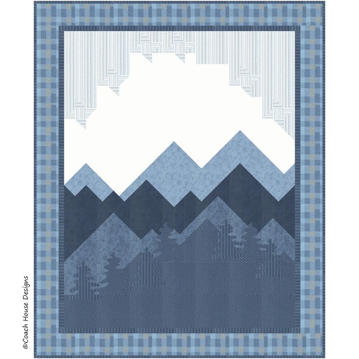 a blue and white quilt with mountains in the background