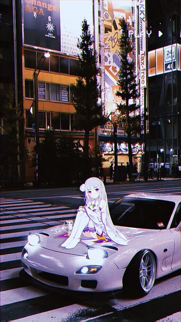 a car that is sitting in the street with a woman on it's hood