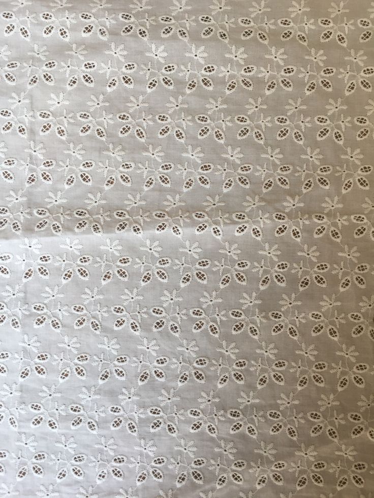 an image of white fabric with small flowers on the top and bottom part of it