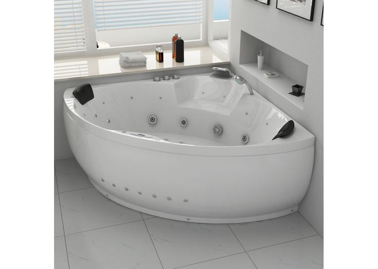 a large white bath tub sitting next to a window