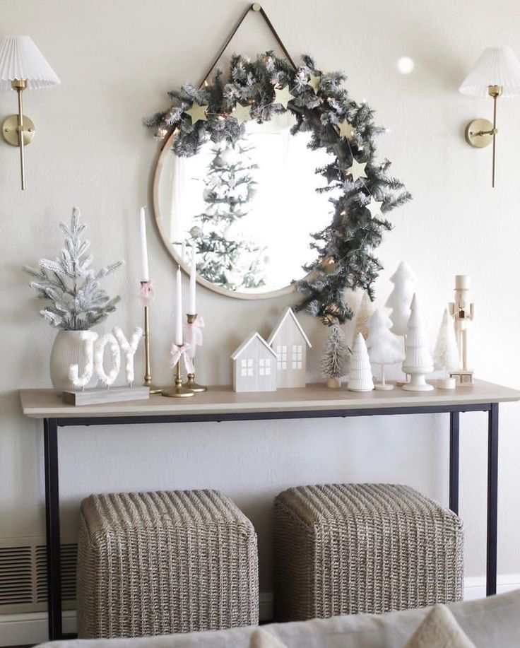 a living room decorated for christmas with ornaments and decorations on the table, along with a round mirror