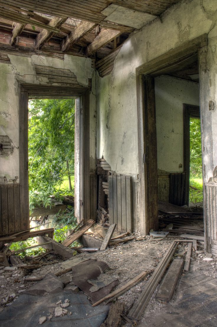 an old run down house with broken windows