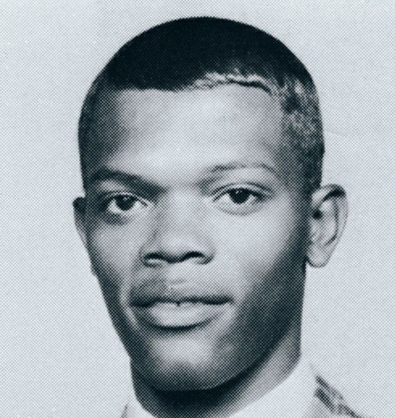 a black and white photo of a young man