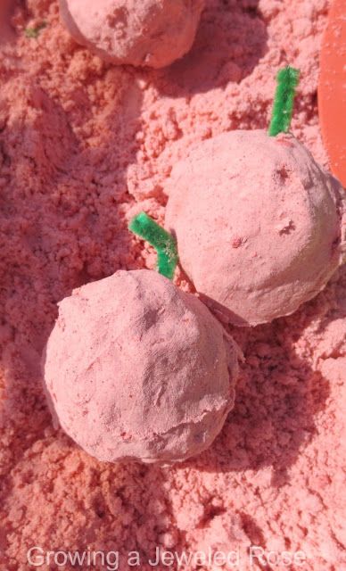 a green caterpillar on top of some pink rocks