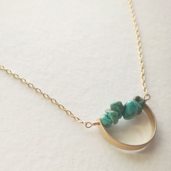 Description A line of semi-precious pebbles create the horizon of this gemstone necklace. Brass curved bar with 14K gold dipped chain. Choose your length. Spring ring closure. You choice of clear quartz, unakite, aquamarine or turquoise semi-precious stone. WHAT IS GOLD DIPPED? Gold dipped is the best alternative to solid gold, and that's why we use gold dipped metals in our jewelry designs. Our gold dipped jewelry components have 150-200 layers of pure solid gold over a base metal. Unlike gold- Minimalist Brass Necklace With Gemstone, Minimalist Brass Gemstone Necklace, Modern Turquoise Jewelry For Everyday, Everyday Brass Jewelry With Natural Stones, Everyday Turquoise Brass Jewelry, Minimalist Turquoise Wire Wrapped Jewelry, Everyday Turquoise Wire Wrapped Jewelry, Minimalist Wire Wrapped Jewelry For Everyday, Minimalist Everyday Wire Wrapped Jewelry