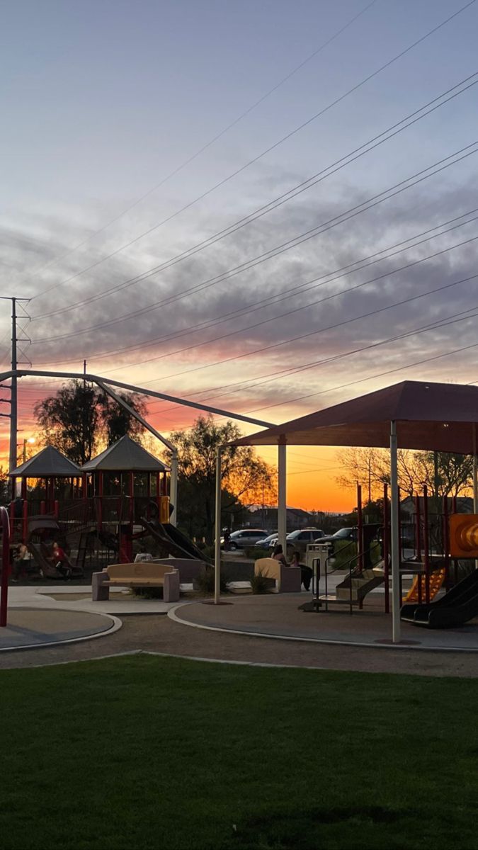 an empty playground at sunset with the sky in the background