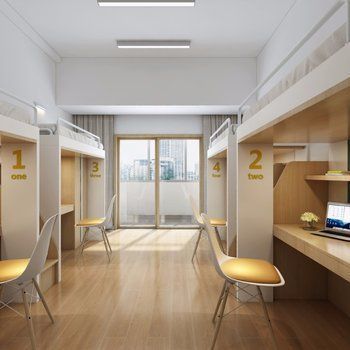 a room with bunk beds and desks on the floor, in front of a window