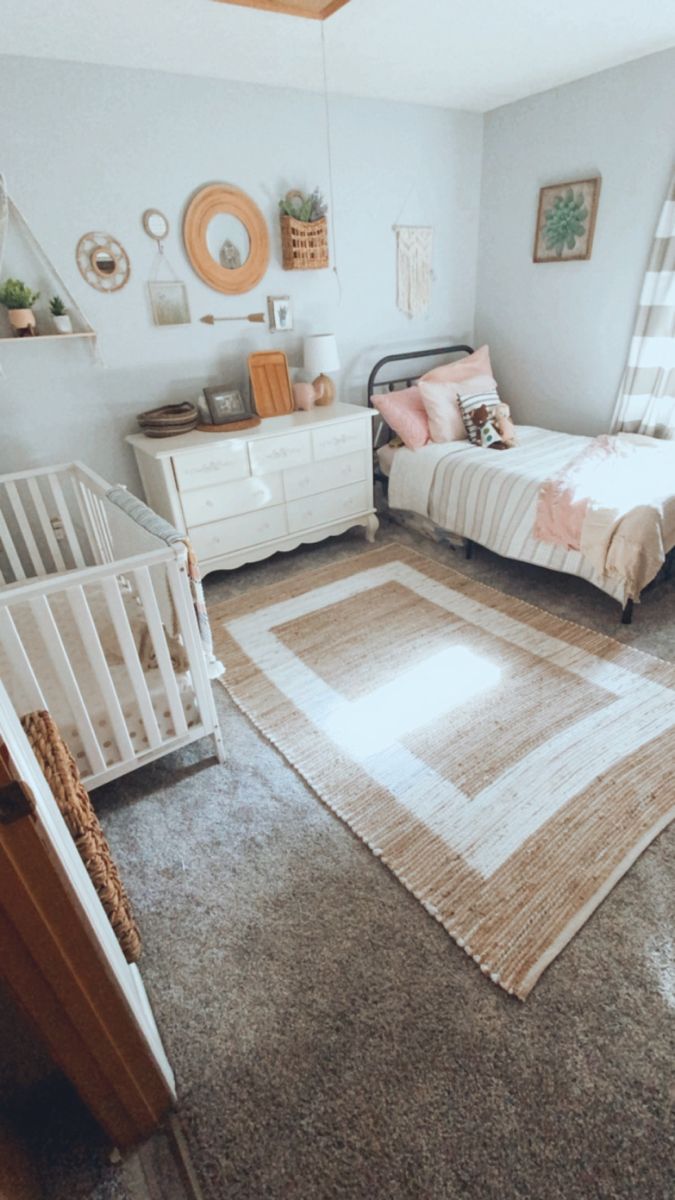 a baby's room with two cribs and a bed in the corner