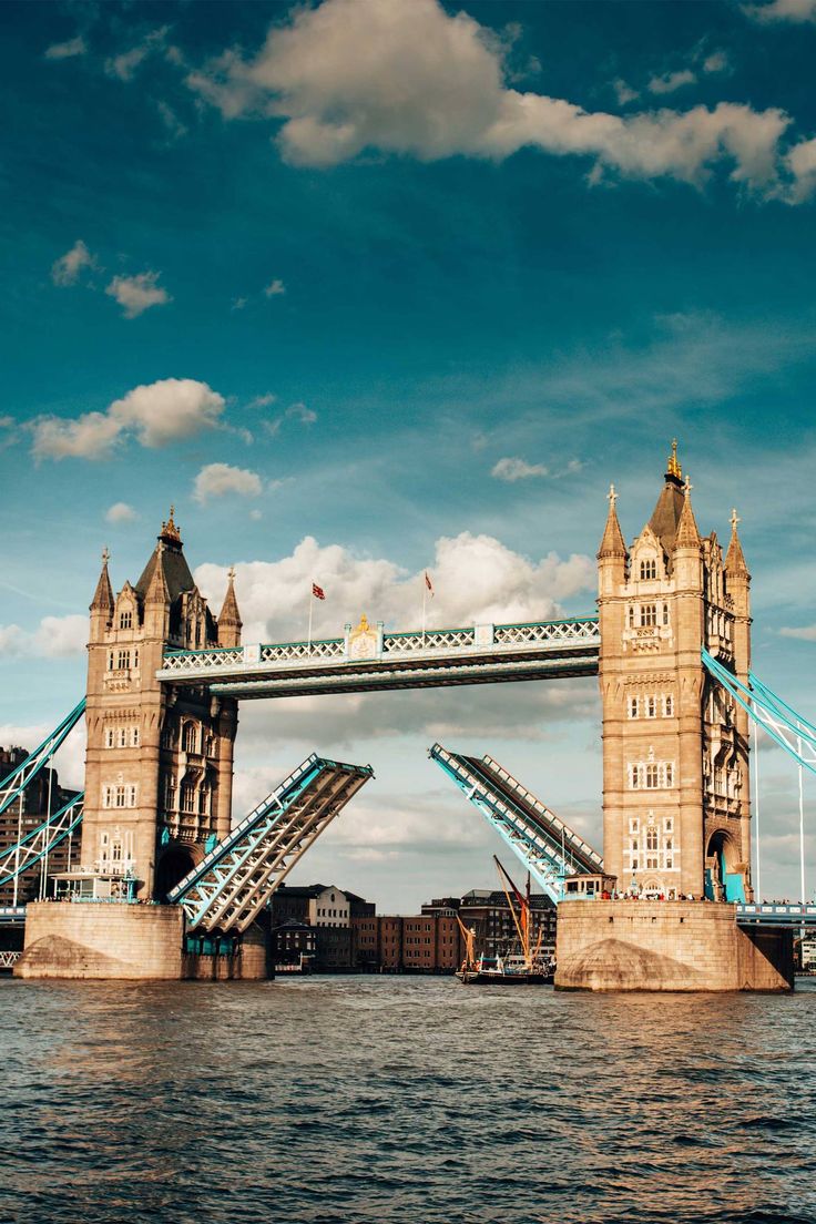 the tower bridge is opened to allow people to go across