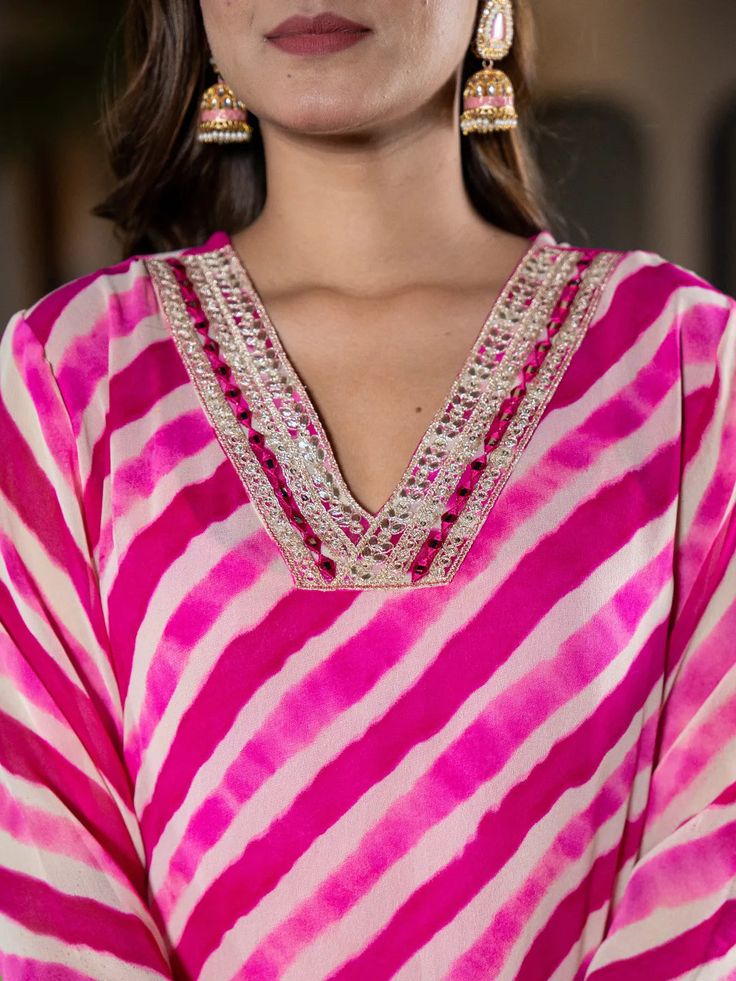 Introducing our, pink leheriya print a line kurta a vibrant fusion of style and culture. Crafted from georgette fabric, it offers comfort and breathability all day long. Embrace the charm of print detailing, perfect for adding a pop of personality to any outfit. Single Piece Fabric: Poly Georgette Color: Pink Neck: V Neck Sleeve: 3/4th Sleeves Style - A Line Shape with Regular Style Work Done: Leheriya Print & Mirror Work Length - Calf Length Washing Instructions: Dry Clean Lehariya Kurti Designs, Leheriya Kurti, Print Mirror, A Line Kurta, Sleeves Style, Cotton Suits, Georgette Fabric, Suit Designs, Mirror Work