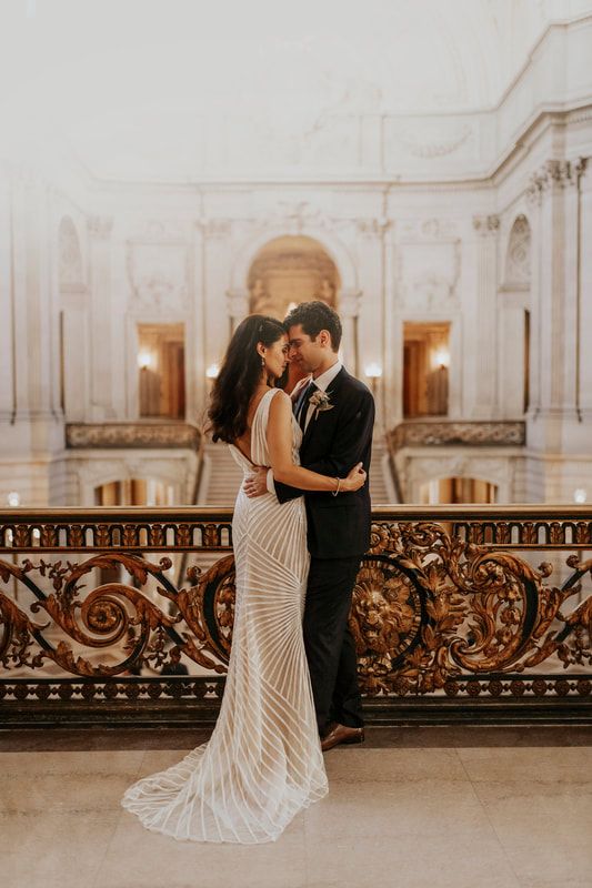 a bride and groom standing in front of a balcony