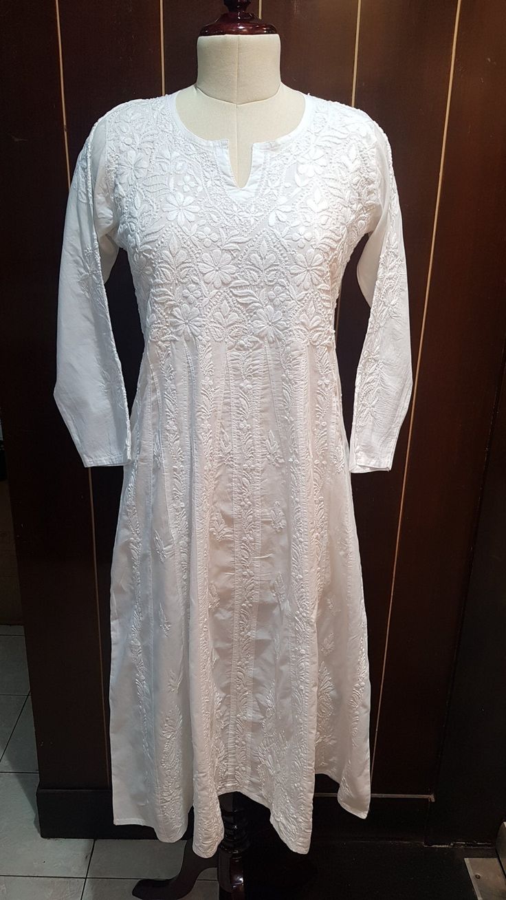 Our Summery Martha Dress in White amazes you with its perfectly aligned Fish Kali and gorgeous Embroidery on its bodice and throughout its length. We have used 100% cotton cambric which is thicker woven and can be worn without a liner. Length stands at 46 inches. This style runs perfectly true to size as it has a bodice and is a fit and flare. So for the sake of comfort, you should order a size up. Available in sizes : XS - bust 34 S - bust 36 M - bust 38 L - bust 40 XL - bust 42 0X - bust 44 Cotton Embroidered Dress With Chikankari And V-neck, White Cotton Maxi Dress With Chikankari Embroidery, V-neck Chikankari Embroidered Maxi Dress, White Embroidered Mulmul Dress, White Sleeveless Embroidered Cotton Dress, Dress Clothes For Women, Fit And Flare, Bodice, Lace Top