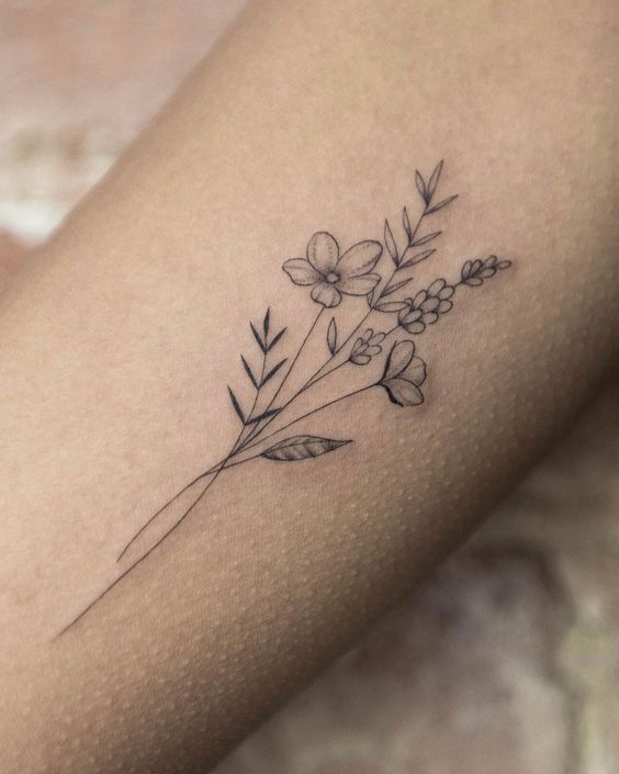 a woman's arm with a flower tattoo on the left side of her body