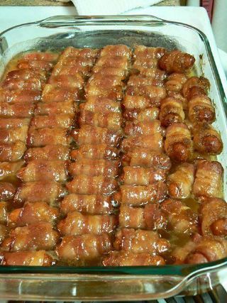 a glass baking dish filled with meat wrapped in sauce and sitting on top of a stove