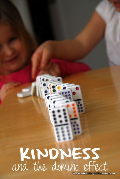 two children playing with dominos on the table