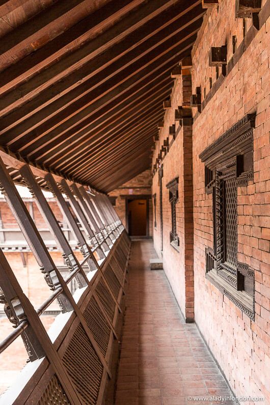 the inside of a building with brick walls and metal railings on either side of it