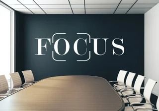 an empty conference room with focus written on the wall