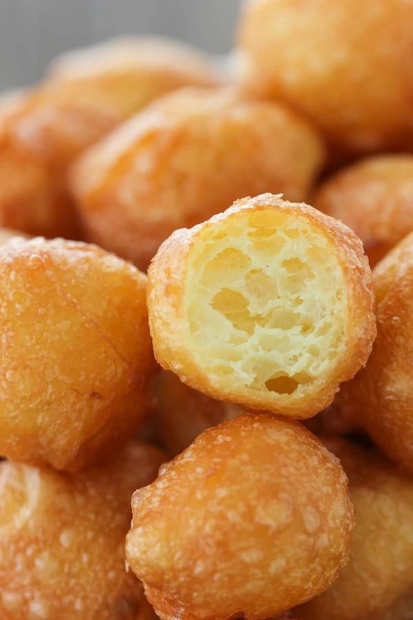 a pile of doughnut holes sitting on top of a white plate