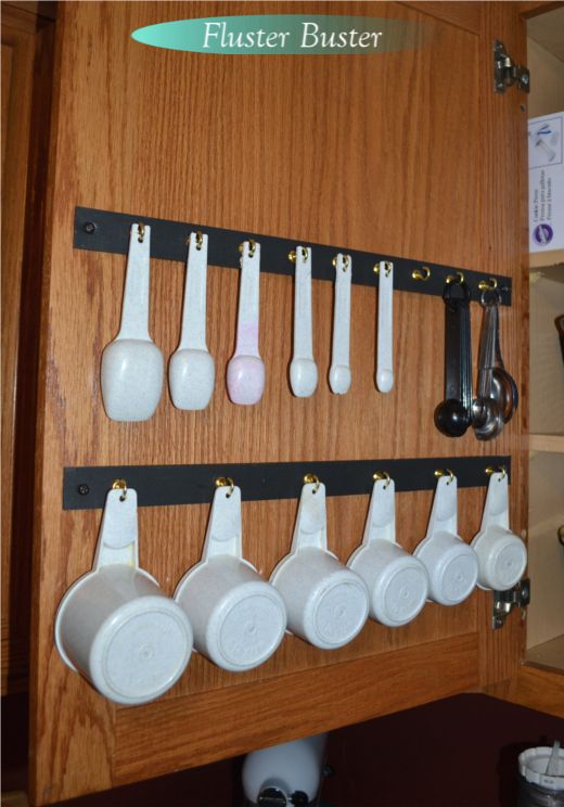 there are many spoons hanging on the wall