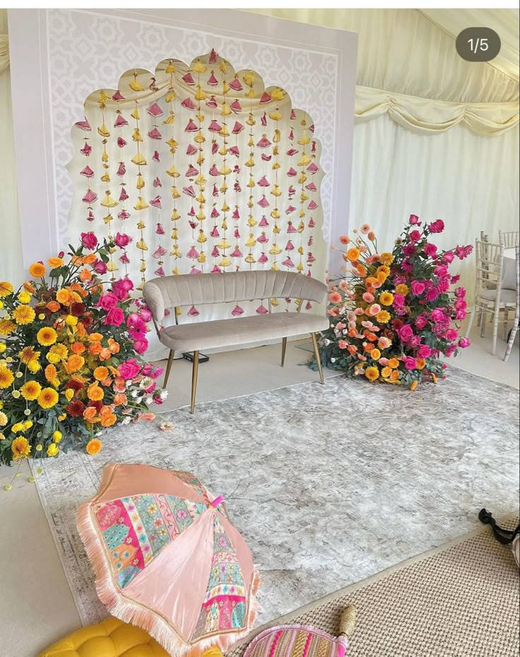 a room decorated with flowers and an umbrella