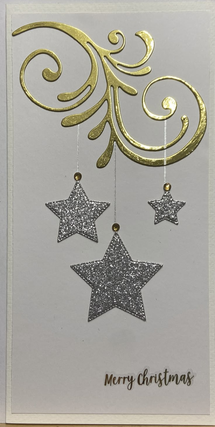 a christmas card with three stars hanging from it