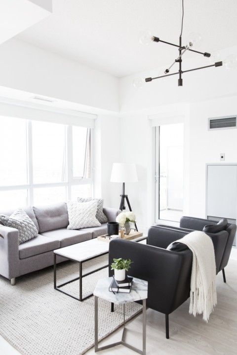 a living room filled with furniture and a large window