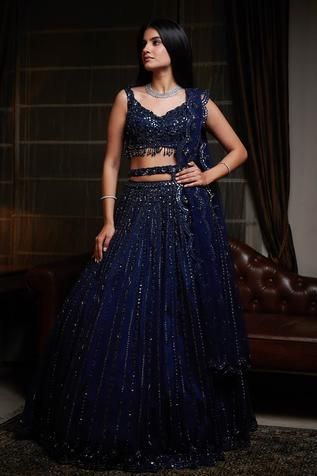 Navy blue lehenga with attached cancan, highlighted with sequin-cutdana and resham embroidery. Comes with cutwork V-neckline padded blouse, dupatta and belt.
Components:4
Embroidered
Neckline:V-Neck
Sleeve Length:Sleeveless
Fabric:Net
Color:Blue
Embroidered blouse with cutwork hem
Beaded tassels
Low back neck with tie-up
Embroidered scallop edged dupatta and belt - Aza Fashions Lahenga Design For Reception, Royal Blue Velvet Lehenga, भारतीय दुल्हन संबंधी, Navy Blue Lehenga, Lehenga Online Shopping, Gown Dress Party Wear, Indian Dress Up, Bridal Lehenga Online, Reception Bride