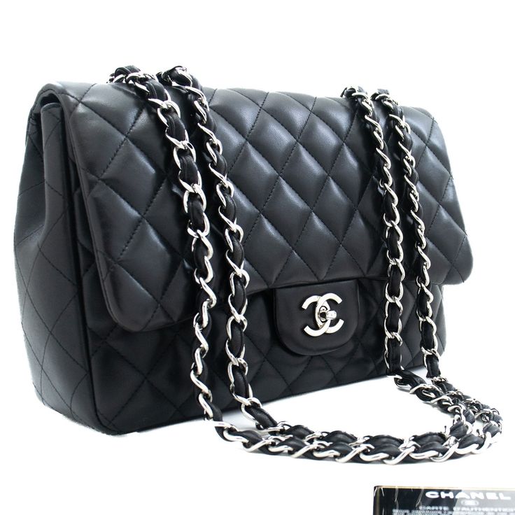 An CHANEL Classic Large 11" Chain Shoulder Bag Flap Black made of black Lambskin j42 This item is Contemporary. The year of manufacture would be 2009. This browser is not supported Conditions & RatingsOutside material: LambskinColor: BlackClosure: Turn LockHardware and chain: Silver-ToneMade in ItalySerial sticker: AttachedSerial #: 13567306 (Same number on the sticker and the card.)Comes with: Full set; ity card, Dust bag, Box, Care bookletOverall: 8 of 10 - The outside is in excellent conditio Chanel Jumbo, Pink Chanel, Classic Handbags, Black Clutch, Double Chain, Day Bag, Black Queen, Chanel Black, Chain Shoulder Bag