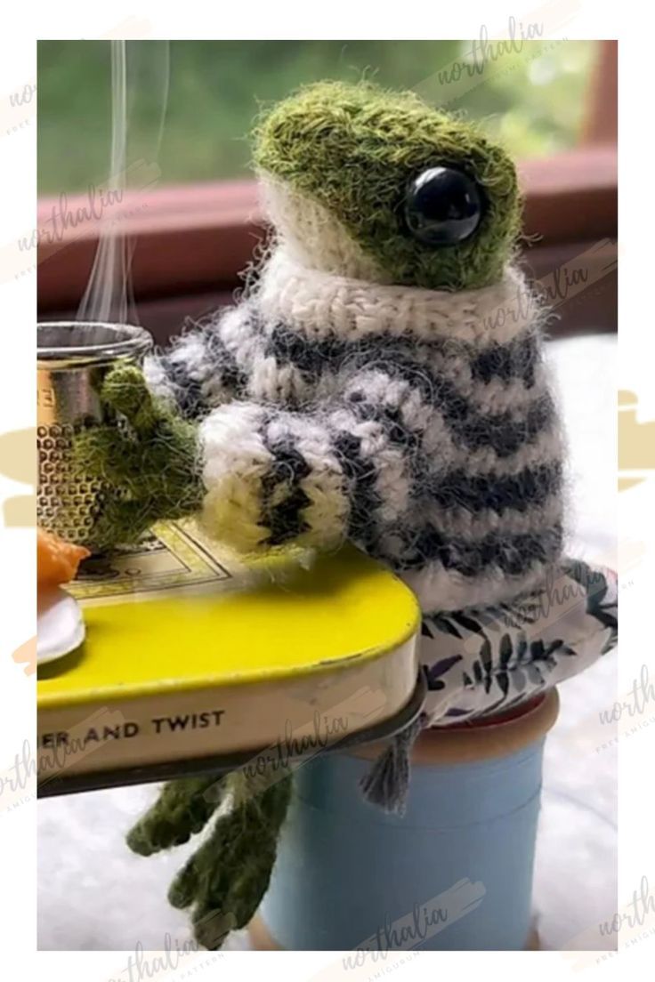 a stuffed animal sitting on top of a table next to a cup and saucer