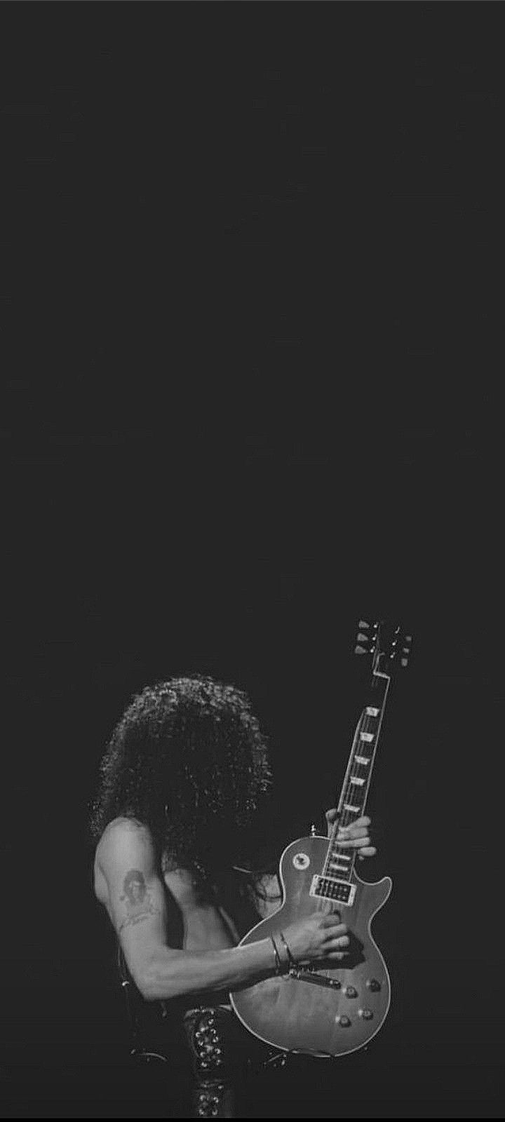 a black and white photo of a man with an electric guitar