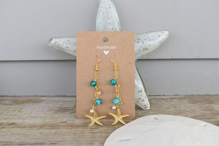 These beachy dangle earrings are handmade and hand assembled with beachy vibes in mind!  The material is delicate and should not be worn in water or with oils and lotions! Handmade Coastal Jewelry For Summer, Summer Starfish Charm Dangle Earrings, Summer Dangle Earrings With Starfish Charm, Handmade Drop Earrings For The Beach, Ocean-inspired Beach Earrings With Ear Wire, Beach Wire Wrapped Drop Earrings, Handmade Adjustable Ocean-inspired Earrings, Handmade Beachy Green Jewelry, Bohemian Summer Jewelry In Ocean Color