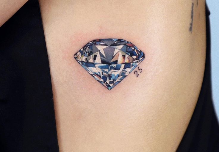 a woman's stomach with a diamond tattoo on it