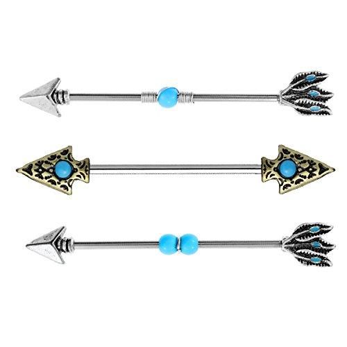 three different types of piercings with blue stones and arrows on them, one is gold