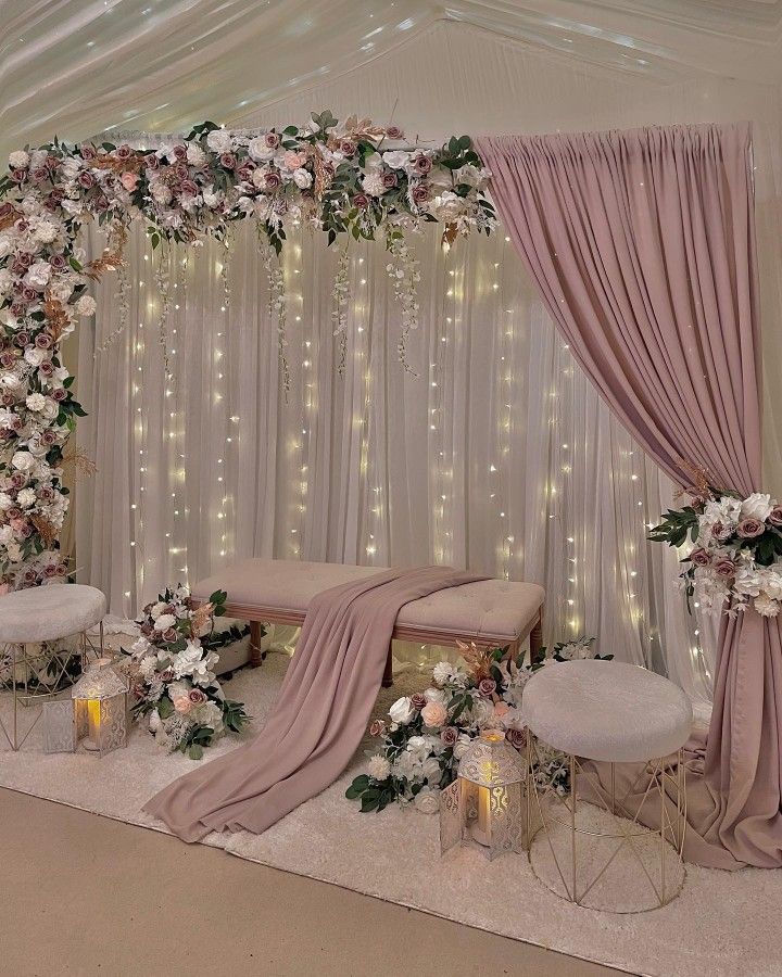 a decorated stage with flowers and candles on the side for a wedding ceremony or reception