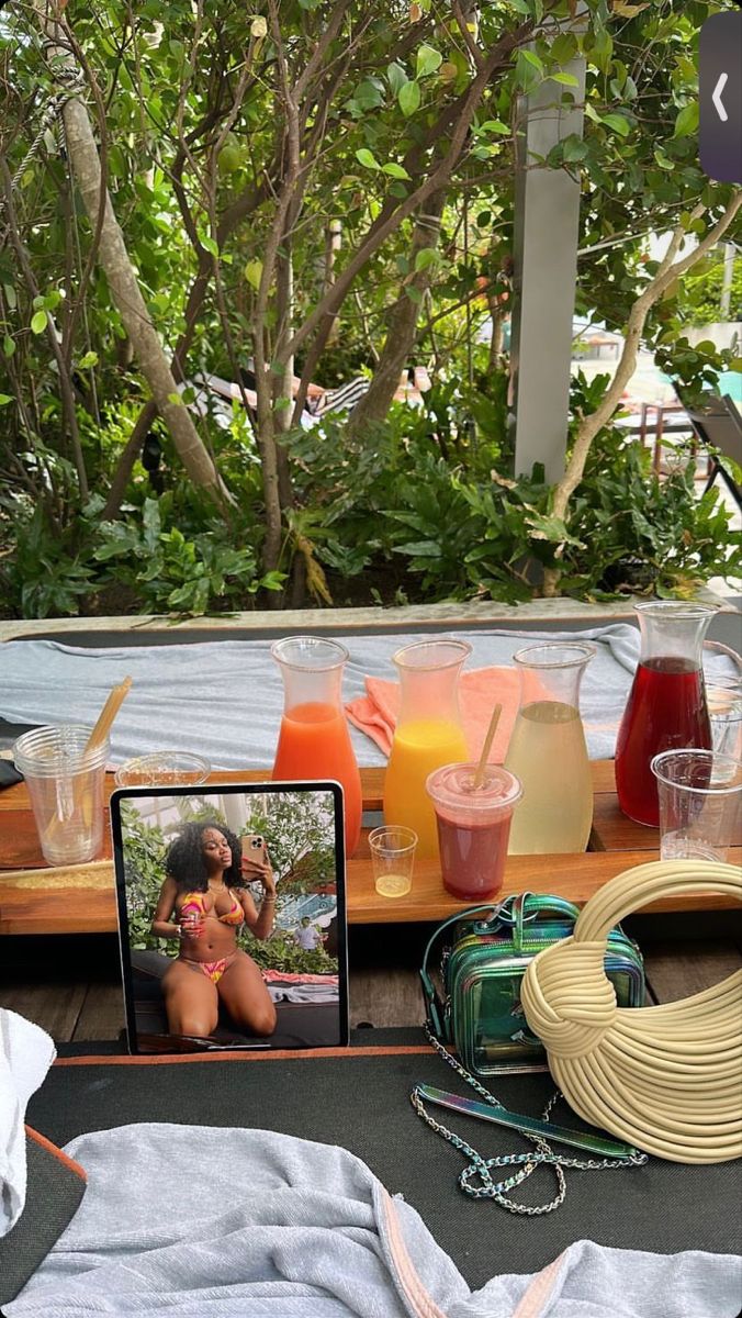 a table topped with drinks and pictures of women in bikinis on top of it