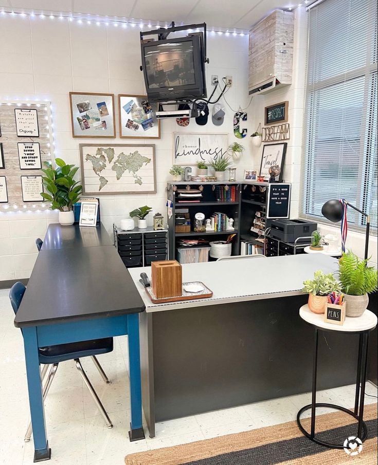 an office with a desk and television in the corner