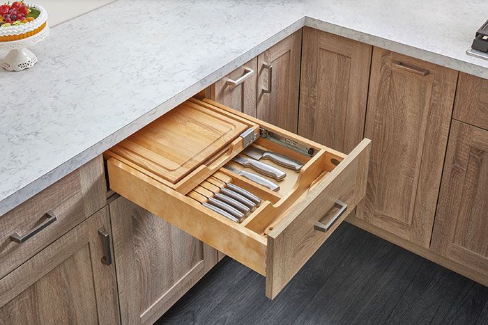 an open drawer in the middle of a kitchen