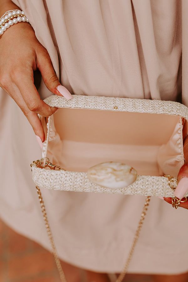 - Embrace luxe villa vibes with this chic woven clutch! It's simple design and trendy stone clasp accent proves that less is more when it comes to elevating a resort ready look. - Woven material over a hard, rectangular shell - Gold hardware - Hinge and clasp closure with a marbled stone clasp - A detachable chain shoulder strap - A fully lined interior Elegant White Woven Straw Bag, Chic Rectangular Straw Bag With Pearl Handle, Chic Natural Straw Bag With Pearl Handle, Elegant Beige Straw Bag With Pearl Handle, Chic Rectangular Straw Bag For Formal Occasions, Elegant Cream Woven Straw Bag, Chic Formal Rectangular Straw Bag, Chic Straw Bag With Pearl Handle For Vacation, Chic Straw Bag With Pearl Handle