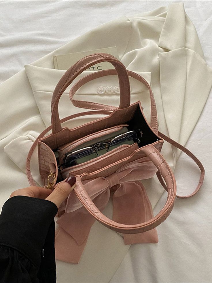 DETAILS PU Bow decor Cute bag Detachable Strap 7.5" L * 3.7" W * 5.5" H Chic Rectangular Bag With Detachable Bow, Elegant Crossbody Shoulder Bag With Bow, Black Rectangular Bag With Bow, Pink Shoulder Bag With Bow, Pink Heart-shaped Bag With Zipper Closure, Bow Decor, Square Bag, Cute Bag, White Bag