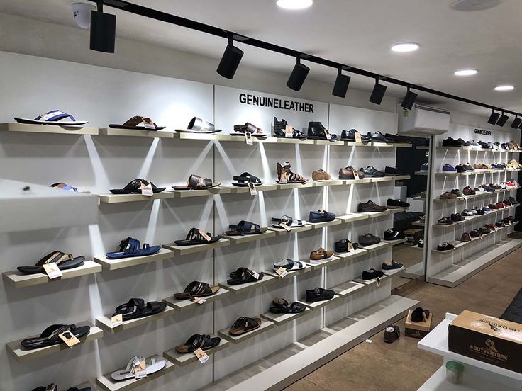 there are many shelves with shoes on them