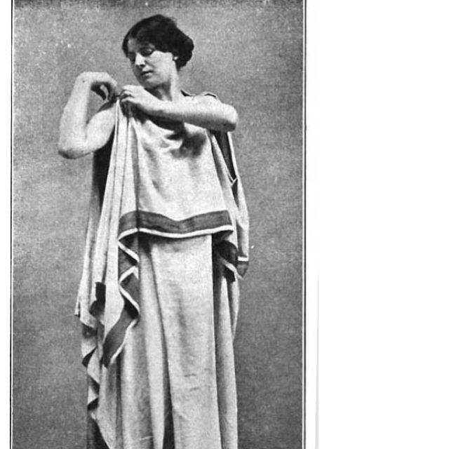 an old black and white photo of a woman dressed in roman garb with her arms crossed