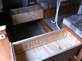 the inside of a camper with drawers in it