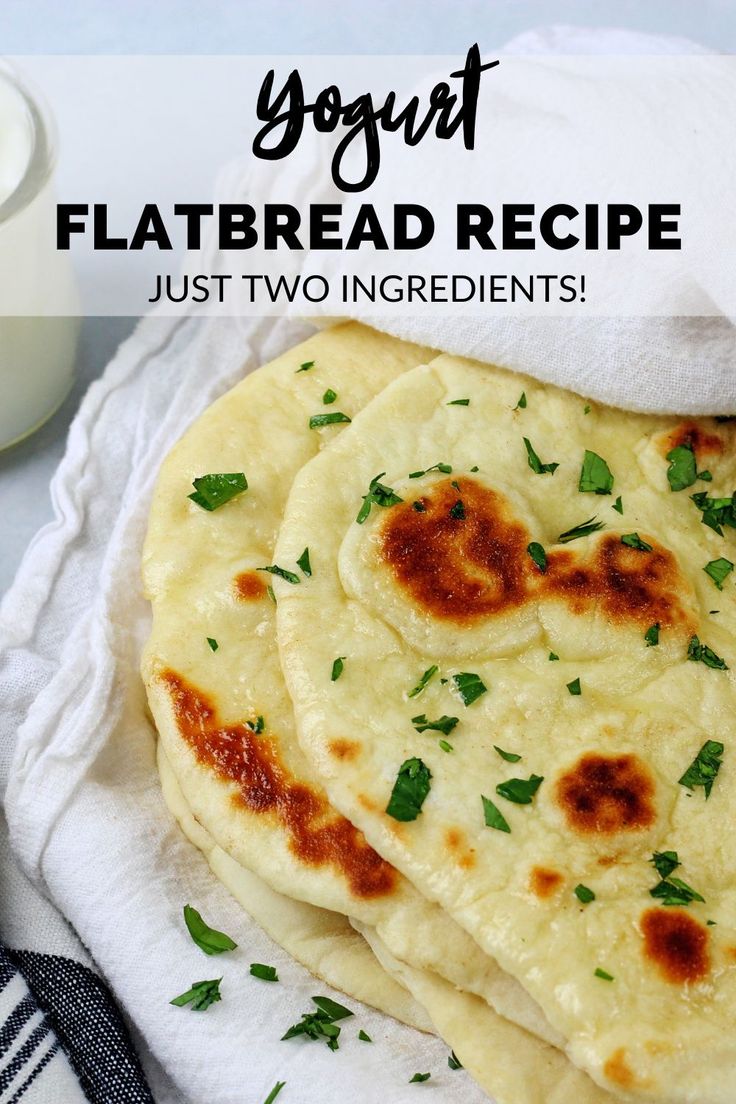 three flatbreads are sitting on a towel next to a bottle of yogurt