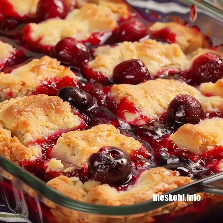 a close up of a pie with cherries in it and some other toppings