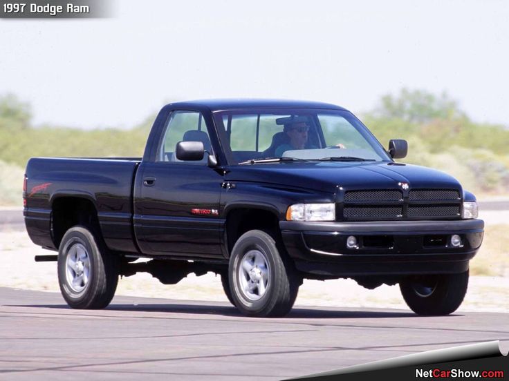 a black pickup truck driving down the road