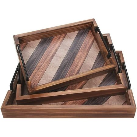 three wooden serving trays stacked on top of each other, one with black and brown stripes