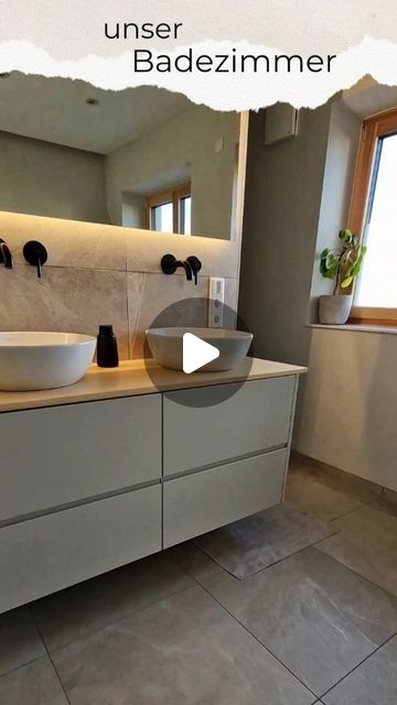 a bathroom with two sinks and a large mirror in it's center wall, along with the words under badezimmer